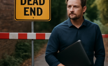 Symbolbild: IT-Manager steht ratlos vor einer Wand aus Monitoren mit Warnmeldungen und roten Fehlersymbolen, im Hintergrund ein digitales Labyrinth, das eine Sackgasse und den Wendepunkt in der IT-Sicherheit symbolisiert.